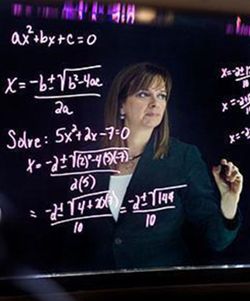 Lori Ogden writing equations on a board
