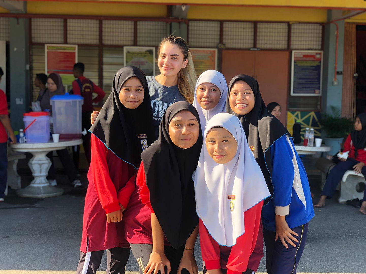 Jana smiling with 5 students