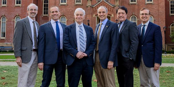 Men of the Gaziano family posing outside in front of Woodburn Hall